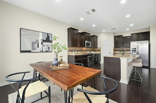 dining space with baseboards, dark wood-type flooring, visible vents, and recessed lighting