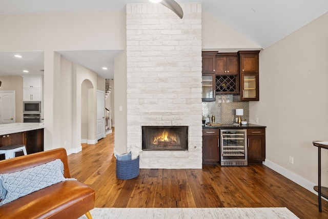8112 Cobblestone, Austin, TX 78735 - indoor wet bar with wine cooler, stainless steel appliances, backsplash, dark wood-style flooring, and baseboards