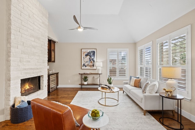 8112 Cobblestone, Austin, TX 78735 - living room featuring dark wood-style flooring, a ceiling fan, beverage cooler, a fireplace, and baseboards