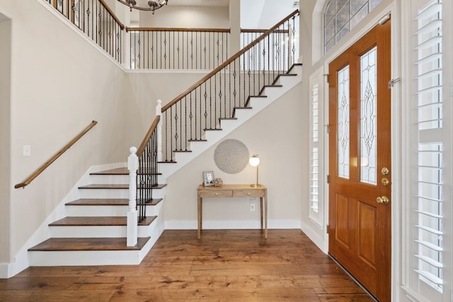 8112 Cobblestone, Austin, TX 78735 - entrance foyer featuring stairs, a high ceiling, wood-type flooring, baseboards, and a chandelier