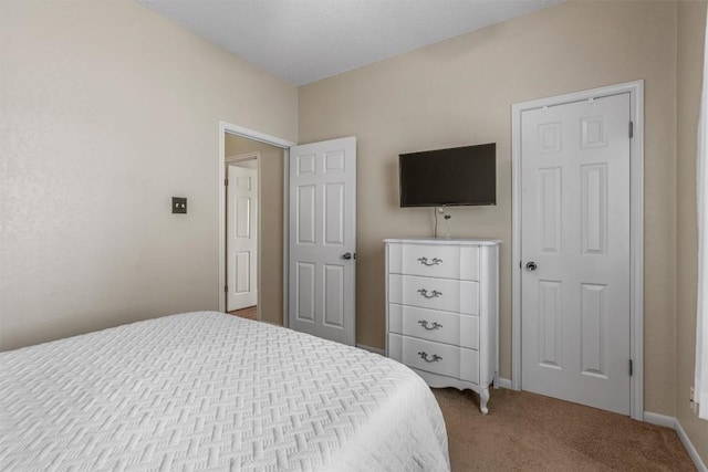 bedroom featuring baseboards and light colored carpet