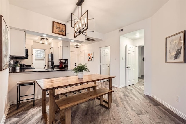 3404 American Dr Unit 3317, Lago Vista, TX 78645 - dining space featuring light wood-style floors, a chandelier, and baseboards