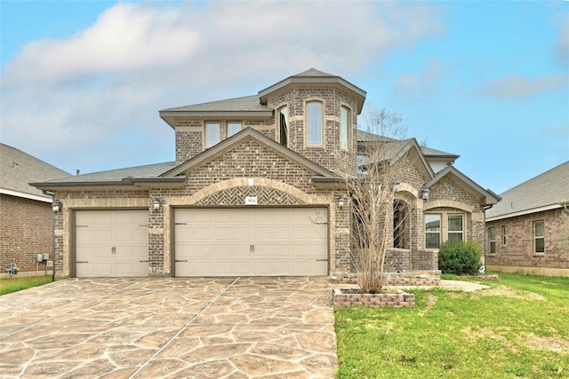 french provincial home featuring driveway, a garage, brick siding, roof with shingles, and a front yard