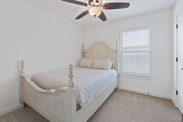 bedroom featuring light colored carpet, baseboards, and ceiling fan