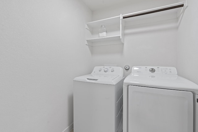 clothes washing area featuring washer and dryer