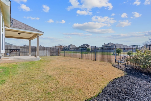 view of yard featuring a patio area and a fenced backyard