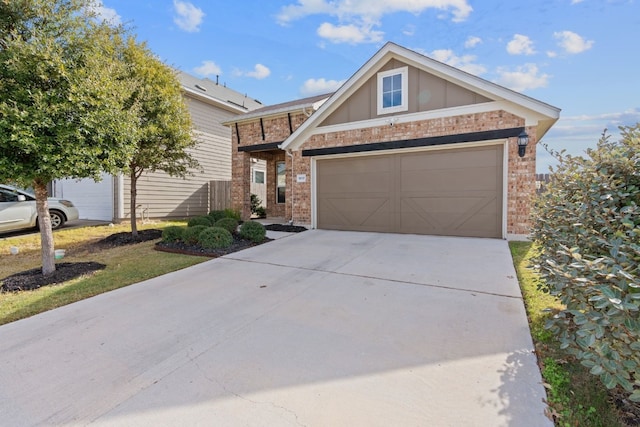 5837 Urbano Bnd, Round Rock, TX 78665 - view of front facade with brick siding, concrete driveway, and a garage