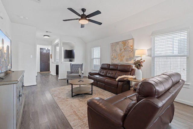 living room with wood finished floors, a ceiling fan, and baseboards