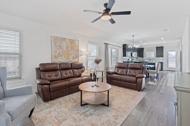 living area with ceiling fan, wood finished floors, plenty of natural light, and recessed lighting