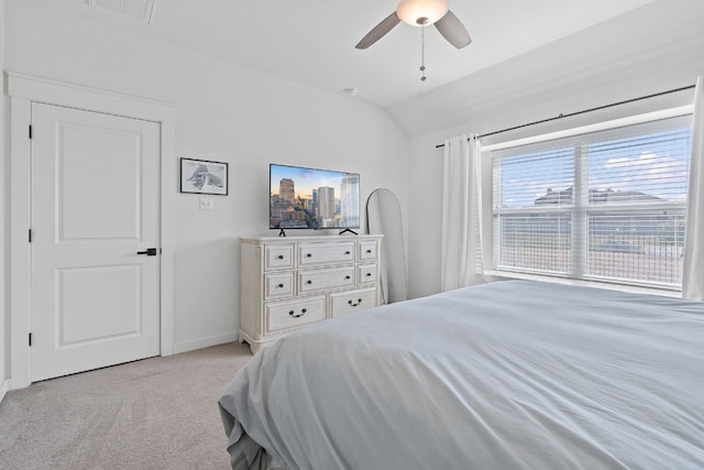 bedroom featuring lofted ceiling, light carpet, baseboards, and ceiling fan
