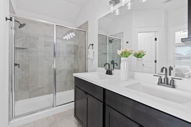 bathroom with a shower stall, tile patterned floors, and double vanity