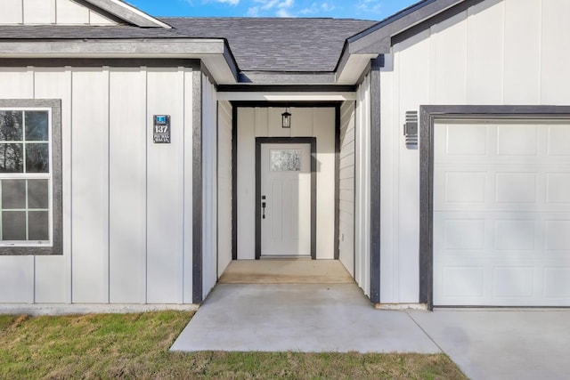 137 Puu Waa Waa Ln, Bastrop, TX 78602 - entrance to property with an attached garage, board and batten siding, and a shingled roof