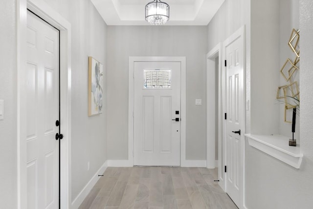 137 Puu Waa Waa Ln, Bastrop, TX 78602 - foyer entrance featuring a chandelier and a tray ceiling