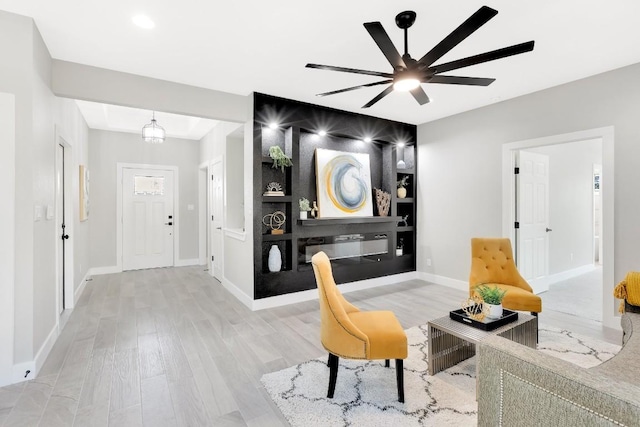 137 Puu Waa Waa Ln, Bastrop, TX 78602 - living area with light wood-style flooring, a ceiling fan, and built in features