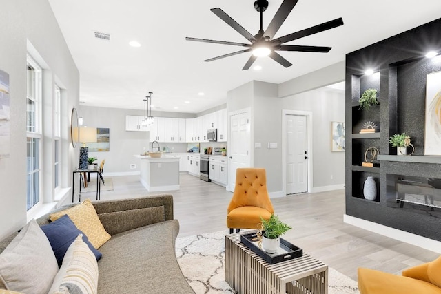 137 Puu Waa Waa Ln, Bastrop, TX 78602 - living room featuring a ceiling fan, light wood-style flooring, and recessed lighting
