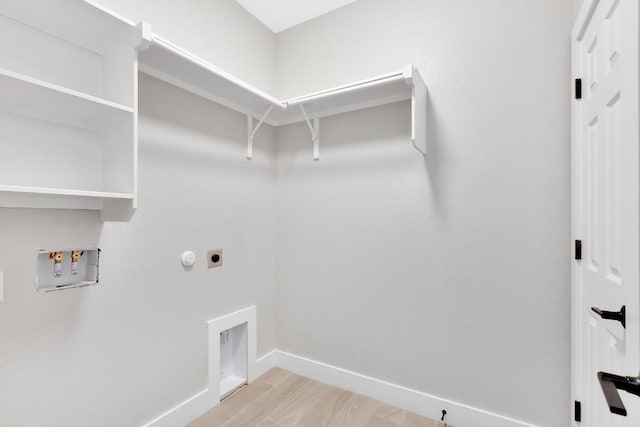 137 Puu Waa Waa Ln, Bastrop, TX 78602 - washroom with hookup for a washing machine, light wood-style flooring, electric dryer hookup, and hookup for a gas dryer