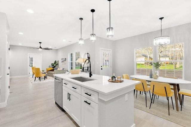 137 Puu Waa Waa Ln, Bastrop, TX 78602 - kitchen featuring stainless steel dishwasher, decorative light fixtures, white cabinets, an island with sink, and a ceiling fan