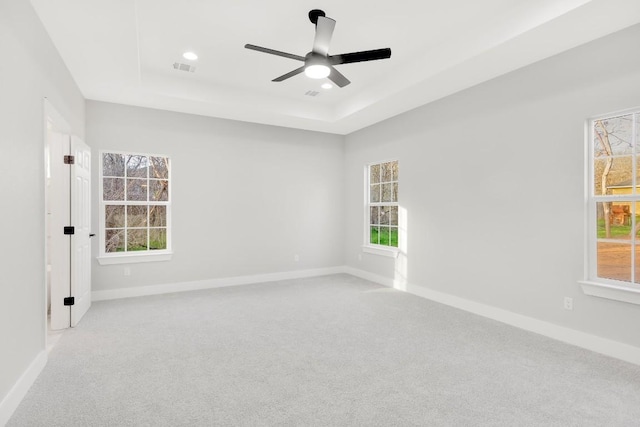 137 Puu Waa Waa Ln, Bastrop, TX 78602 - empty room with a tray ceiling, carpet, plenty of natural light, a ceiling fan, and recessed lighting