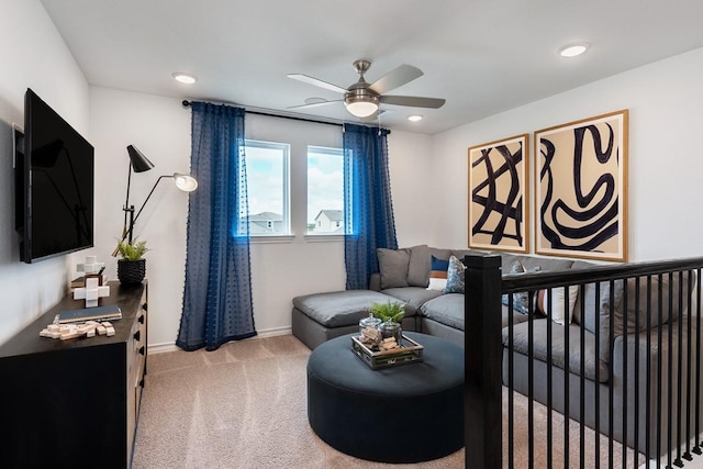 living area with recessed lighting, light colored carpet, ceiling fan, and baseboards