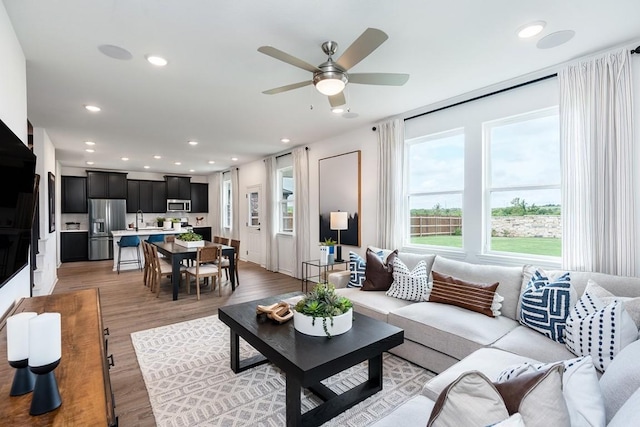 living room featuring a ceiling fan, wood finished floors, and recessed lighting