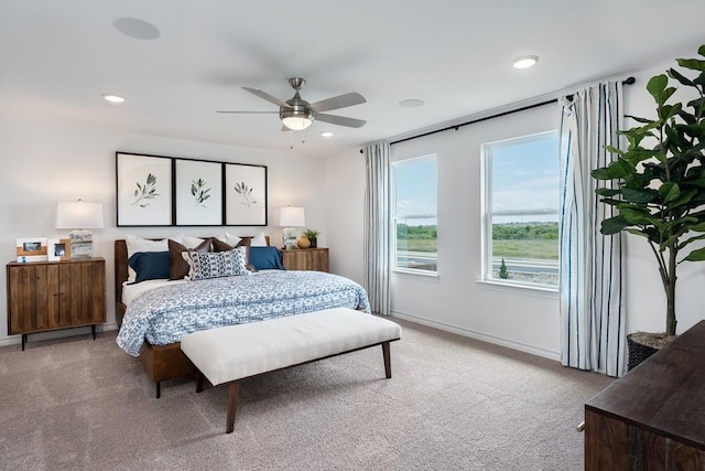 bedroom featuring recessed lighting, light colored carpet, and baseboards