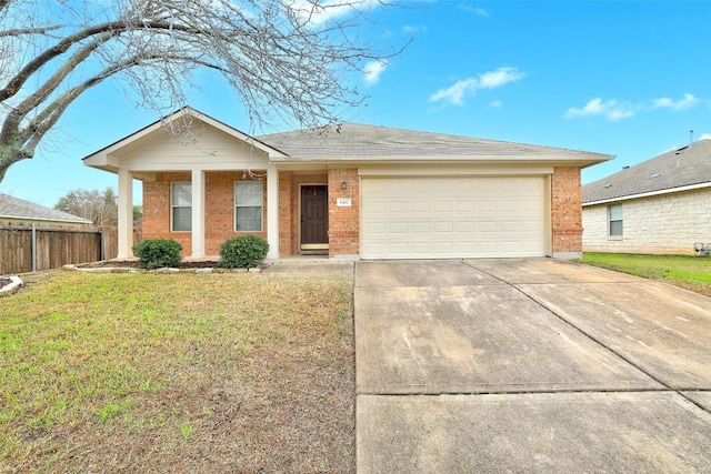 ranch-style home featuring an attached garage, driveway, brick siding, and a front yard