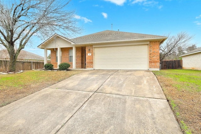 single story home with an attached garage, fence, a front lawn, and brick siding