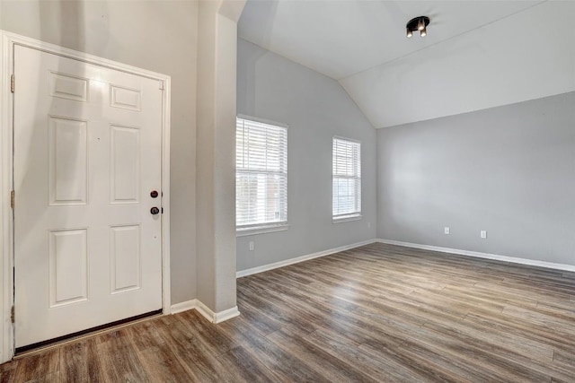 entryway featuring vaulted ceiling, baseboards, and wood finished floors