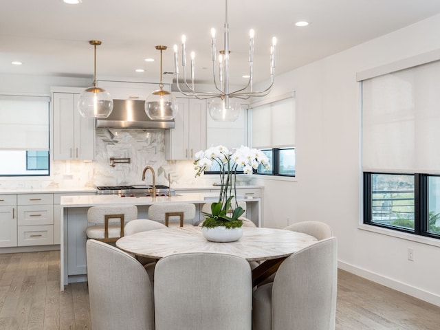 dining space with light wood finished floors, baseboards, and recessed lighting