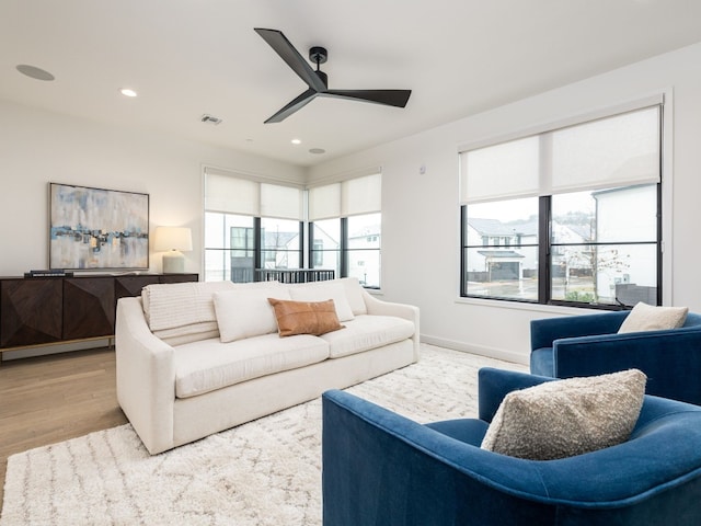 living area featuring ceiling fan, light wood finished floors, visible vents, and recessed lighting