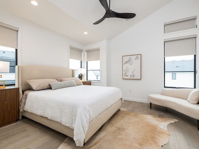 bedroom with baseboards, lofted ceiling, ceiling fan, light wood-type flooring, and recessed lighting