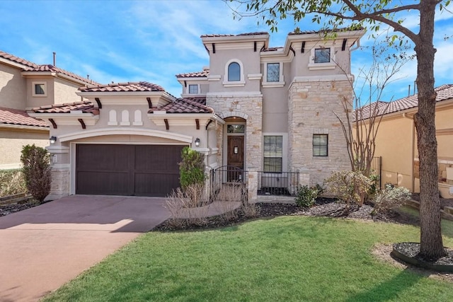 mediterranean / spanish house with a garage, stone siding, concrete driveway, and stucco siding