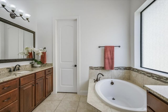 full bathroom with a garden tub, tile patterned flooring, and vanity