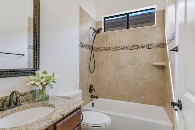 bathroom featuring washtub / shower combination, vanity, and toilet