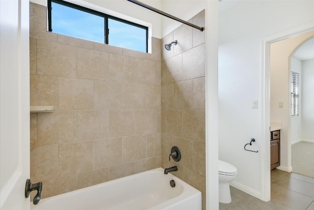 bathroom featuring tile patterned flooring, toilet, bathtub / shower combination, vanity, and baseboards