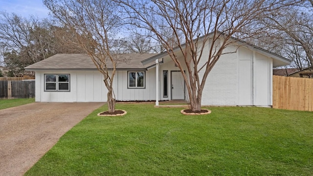 single story home with brick siding, board and batten siding, a front yard, and fence