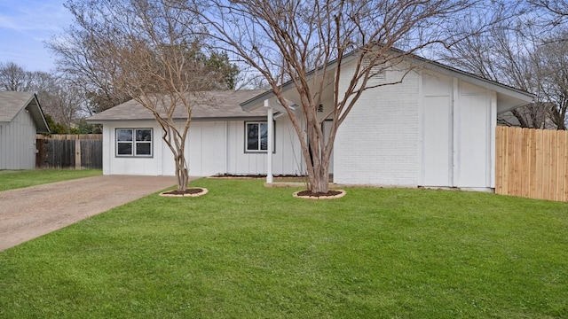 1112 Village Green Dr, Austin, TX 78753 - view of front of home with brick siding, board and batten siding, concrete driveway, and a shingled roof