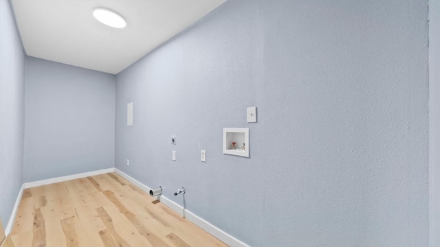 1112 Village Green Dr, Austin, TX 78753 - washroom with electric dryer hookup, hookup for a gas dryer, light wood-type flooring, washer hookup, and baseboards