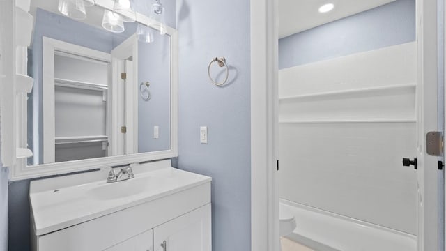 1112 Village Green Dr, Austin, TX 78753 - full bathroom featuring vanity, a textured wall, and toilet