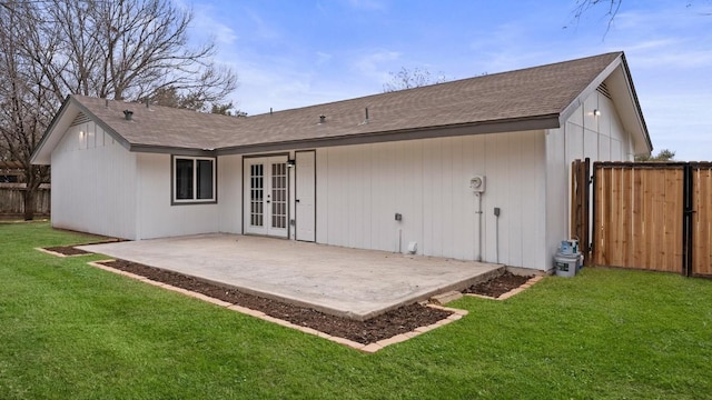 1112 Village Green Dr, Austin, TX 78753 - back of property featuring french doors, a patio, and roof with shingles