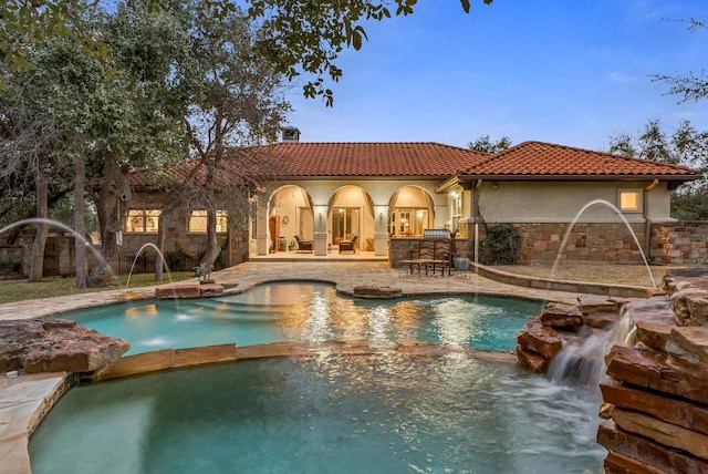 view of swimming pool with a patio area and a pool with connected hot tub