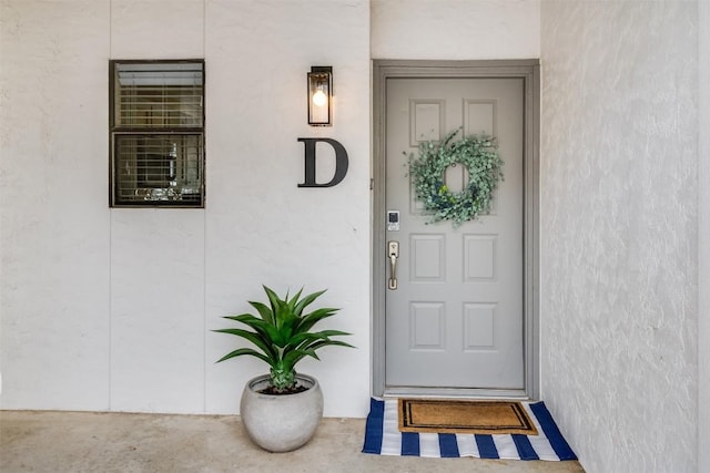 view of exterior entry with stucco siding