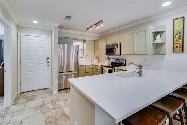 kitchen with visible vents, a peninsula, stainless steel appliances, light countertops, and a sink