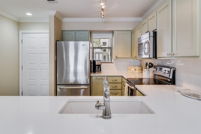 kitchen with a sink, stainless steel appliances, backsplash, and light countertops