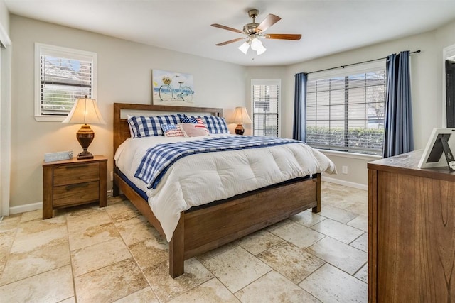 bedroom featuring a ceiling fan and baseboards