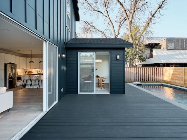 deck featuring fence and a fenced in pool