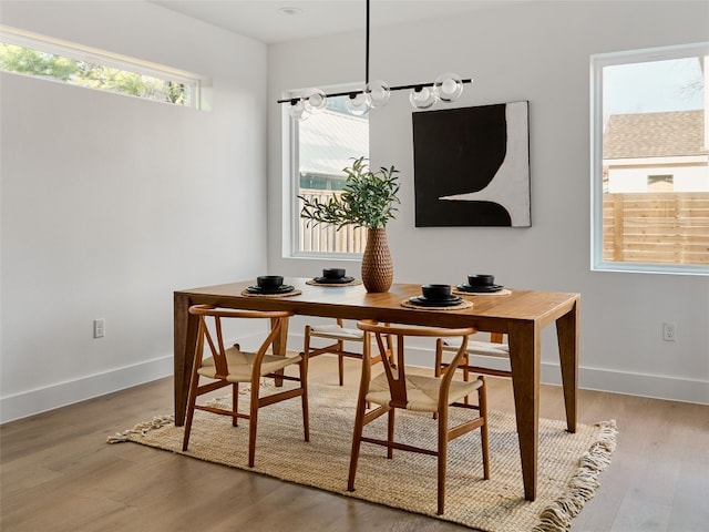 dining space featuring wood finished floors and baseboards