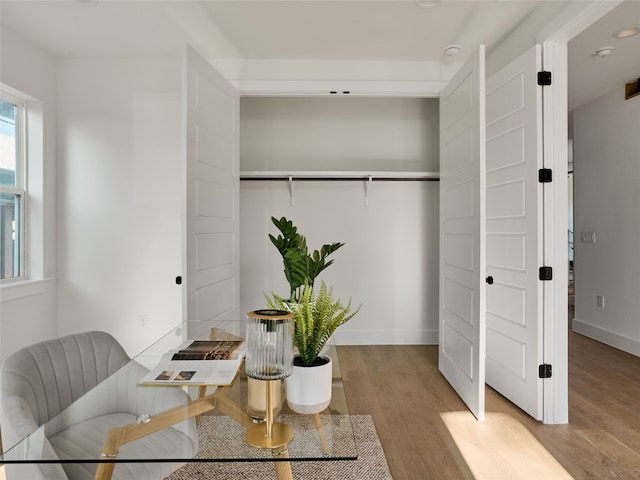 interior space featuring light wood-style flooring and baseboards