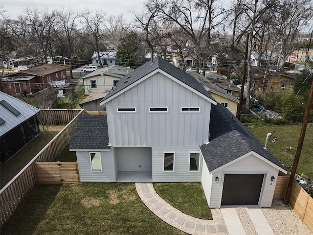 1002 Gullett St Unit 2, Austin, TX 78702 - view of front of property featuring a shingled roof, board and batten siding, driveway, an attached garage, and a residential view