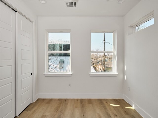 1002 Gullett St Unit 2, Austin, TX 78702 - unfurnished bedroom featuring light wood finished floors, a closet, and baseboards